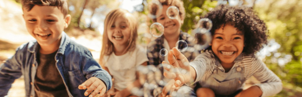 Kids playing with bubbles.